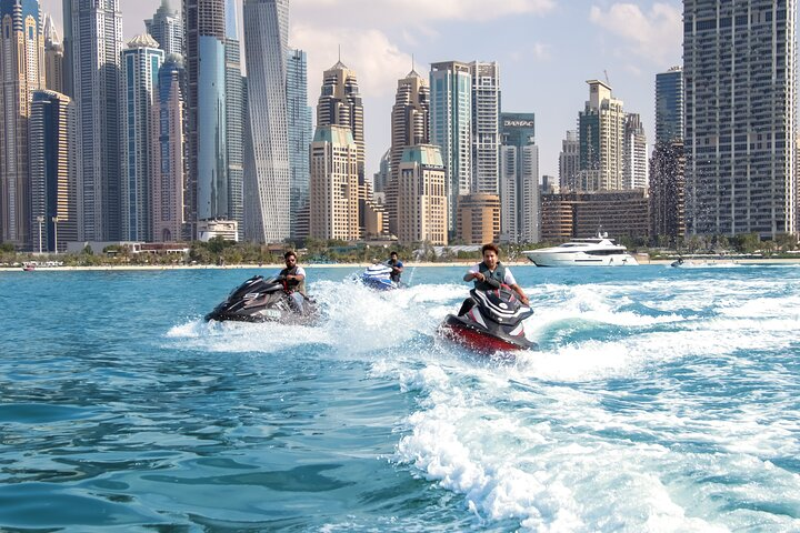 Experience the stunning skyline of Dubai while gliding across the Arabian Gulf on a jet ski. Capture moments of excitement and breathtaking city views in this unforgettable aquatic adventure.